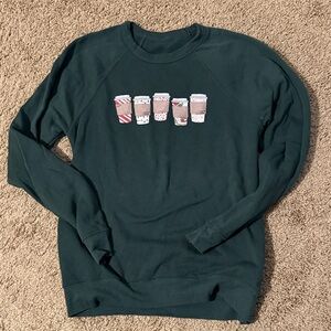 Cozy Dark Green Sweatshirt with Christmas and Winter Coffee Cup Design